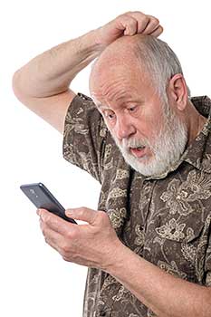 Senior man confused by smartphone